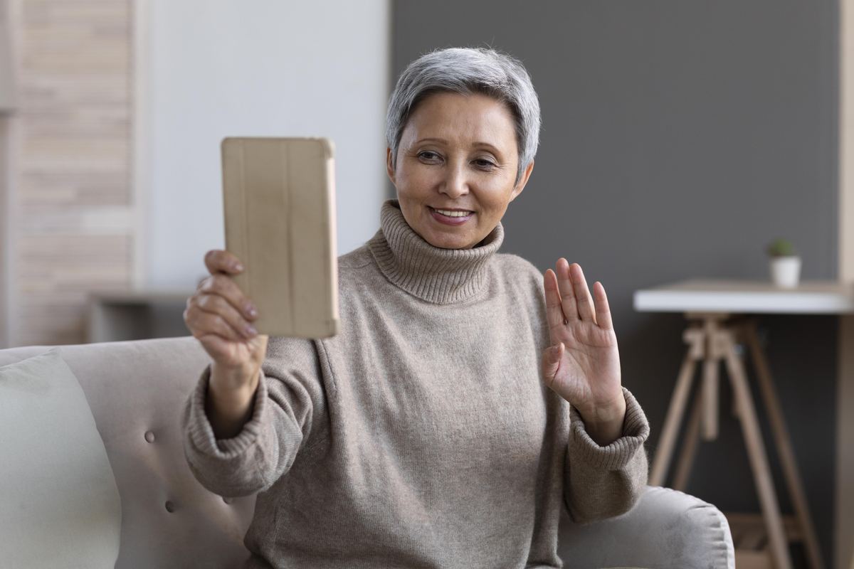 older woman on a family video call at thanksgiving